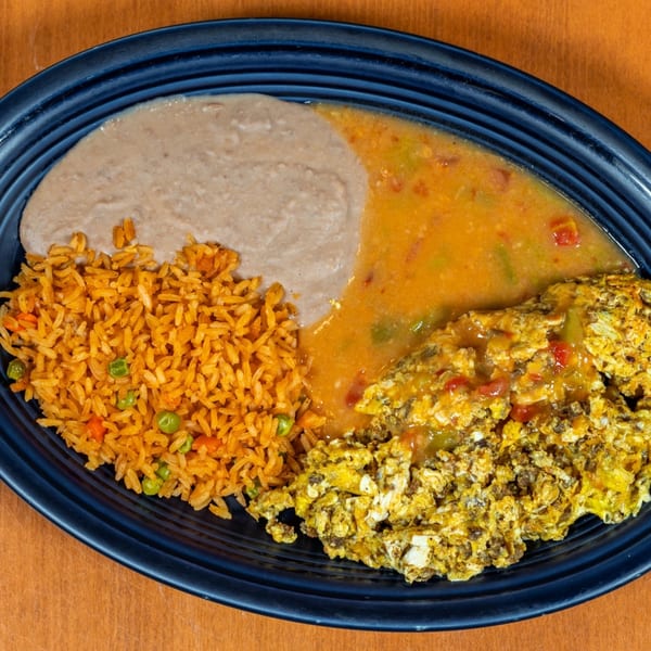 Mi Cocina's Mexican breakfast plate with scrambled eggs, refried beans, and Spanish rice.
